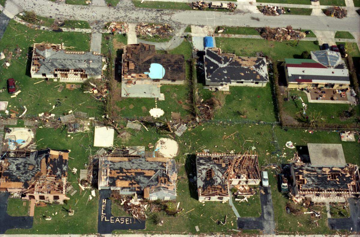 Homes destroyed, "Help Please" spelled out in debris
