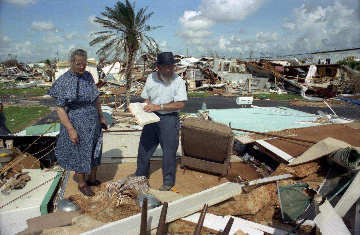 German Baptist husband and wife search through rubble