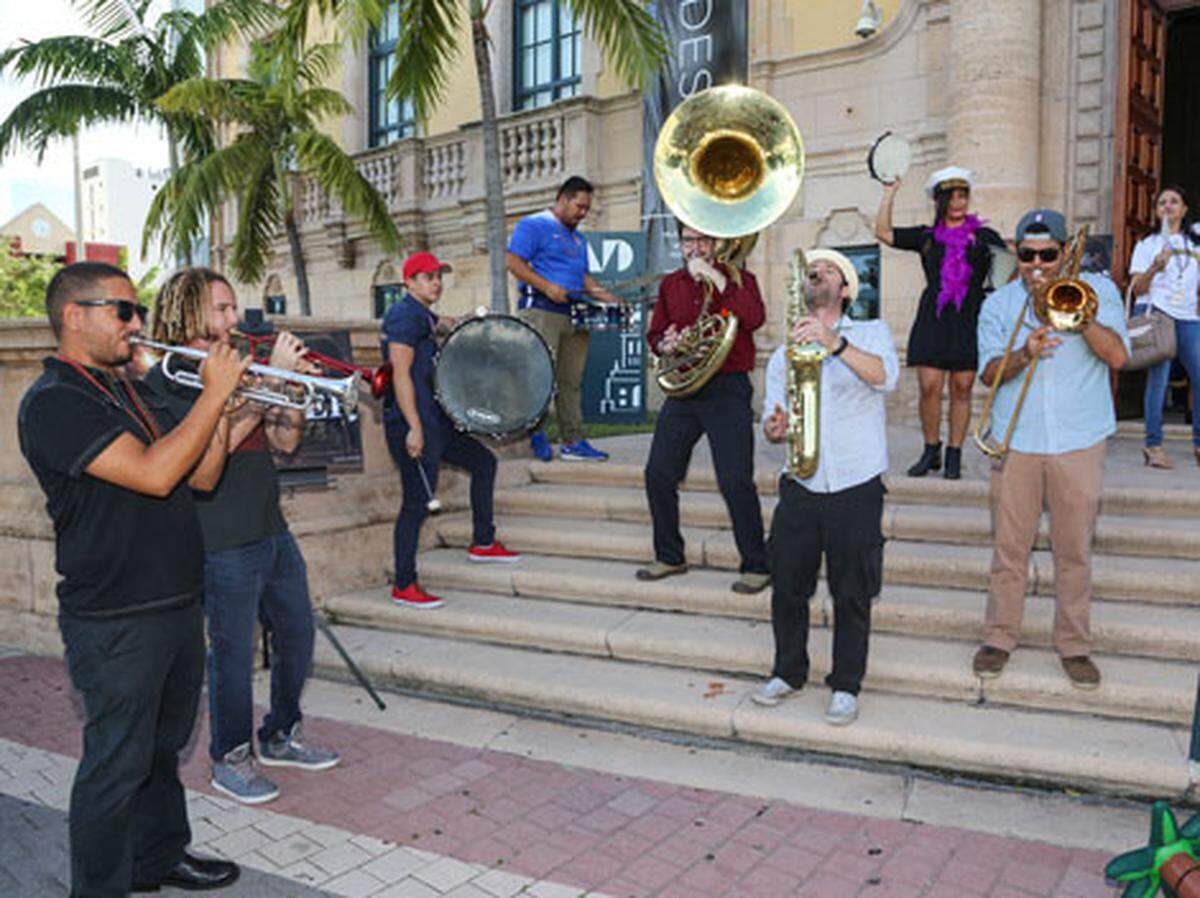 A band performs in front of Freedom Tower during DWNTWN Art Days