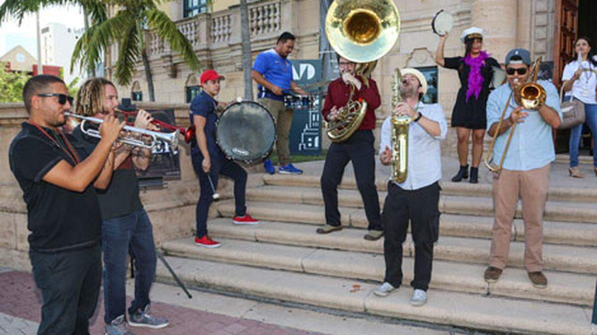 A band performs in front of Freedom Tower during DWNTWN Art Days