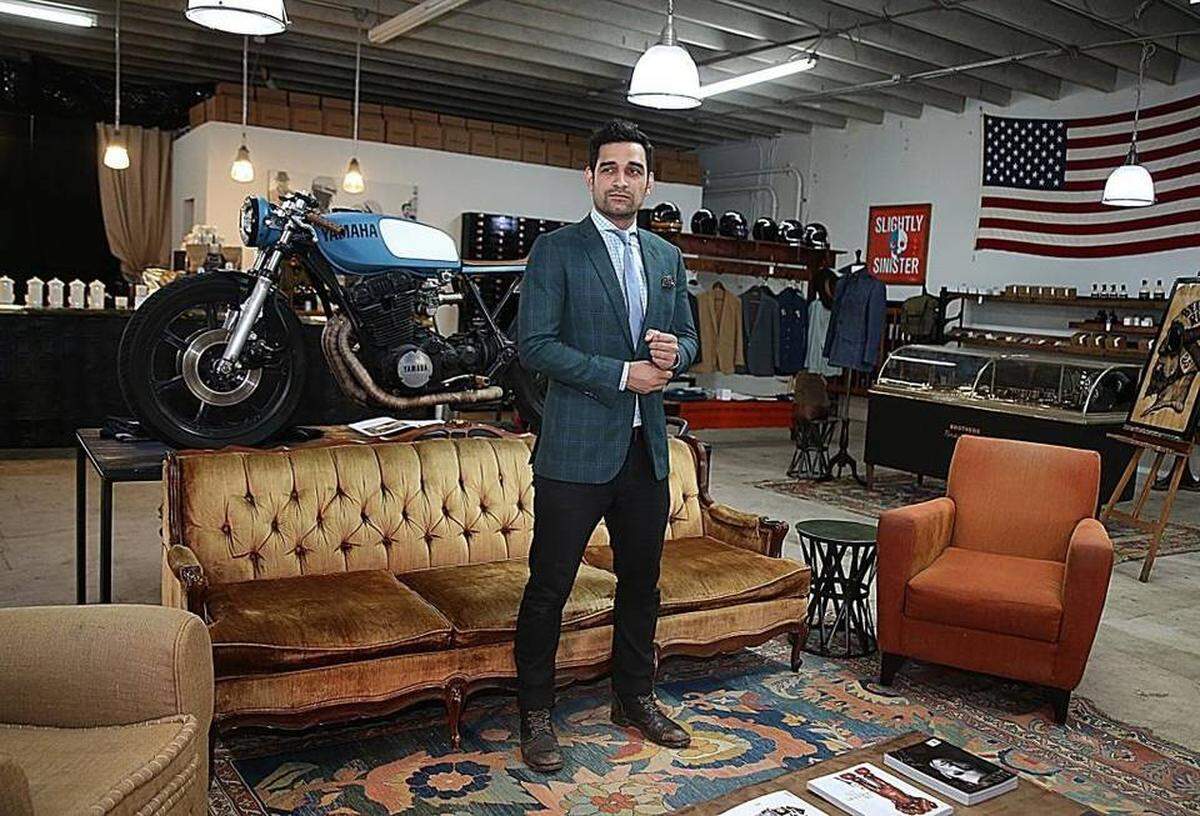 Sebastian Tatano-Ramirez, former creative director at Manhattan custom clothier Alexander Nash, poses at his business, Brothers &amp; Brawlers in Wynwood, a combination of a coffee store, motorcycle shop and men's tailor.
