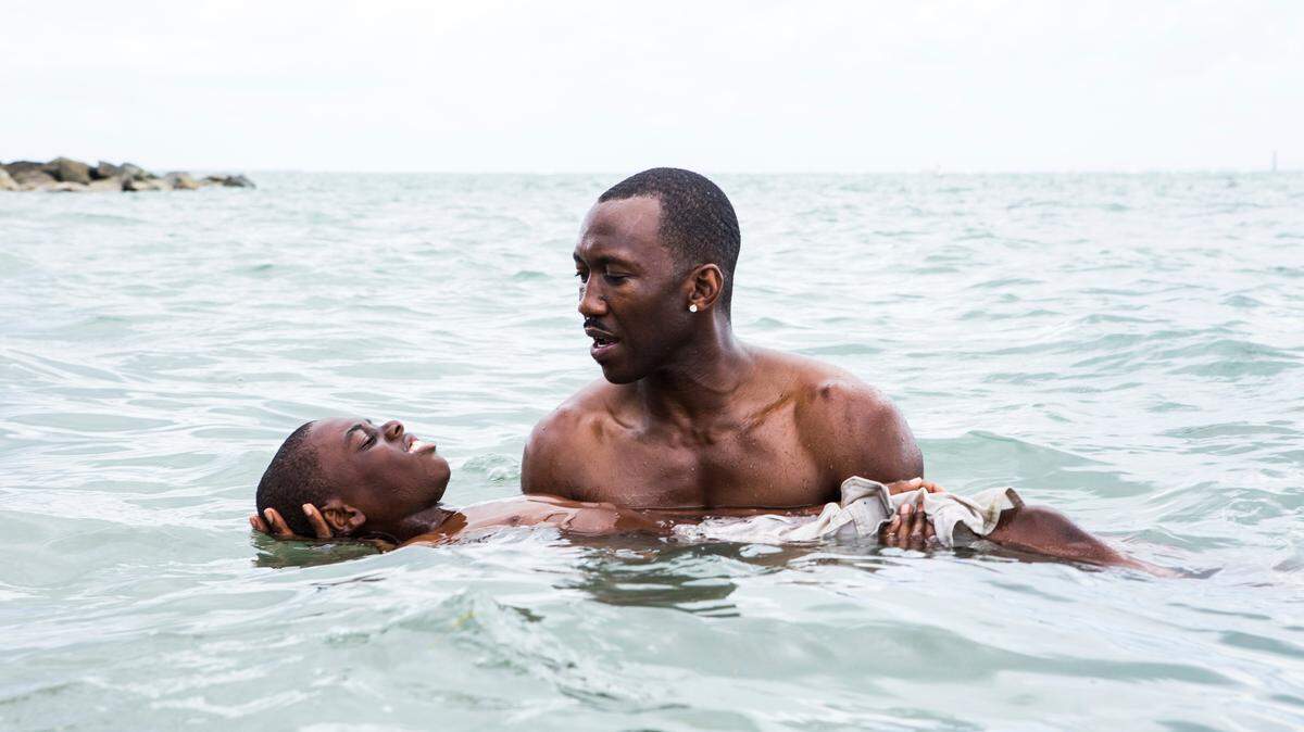 This image released by A24 shows Alex Hibbert, foreground, and Mahershala Ali in a scene from the film, "Moonlight." (David Bornfriend/A24 via AP)
