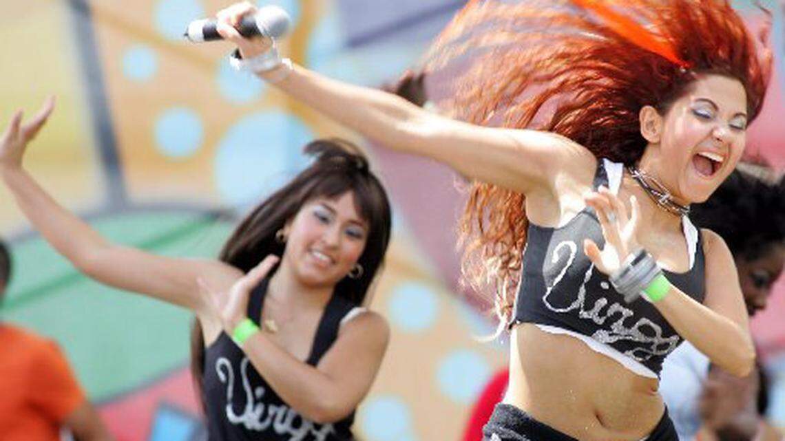 Venezuelan singer Virggi, right, performs at Calle Ocho 2006. AP Photo/Luis M. Alvarez
