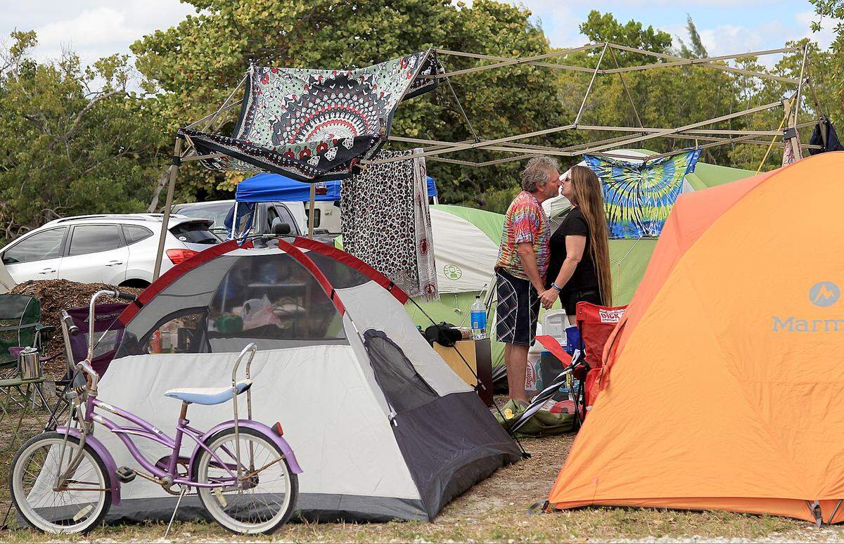 John Bischman, of Lakeland, and Cindy Pless, of Sebastian, Florida share the kiss on the camp grounds at the Grassroots Festival.  On Sunday, February 21, 2016 attendees camped, danced, and enjoyed the musical and culinary offerings of the annual Grassroots Festival on Virginia Key, Florida.