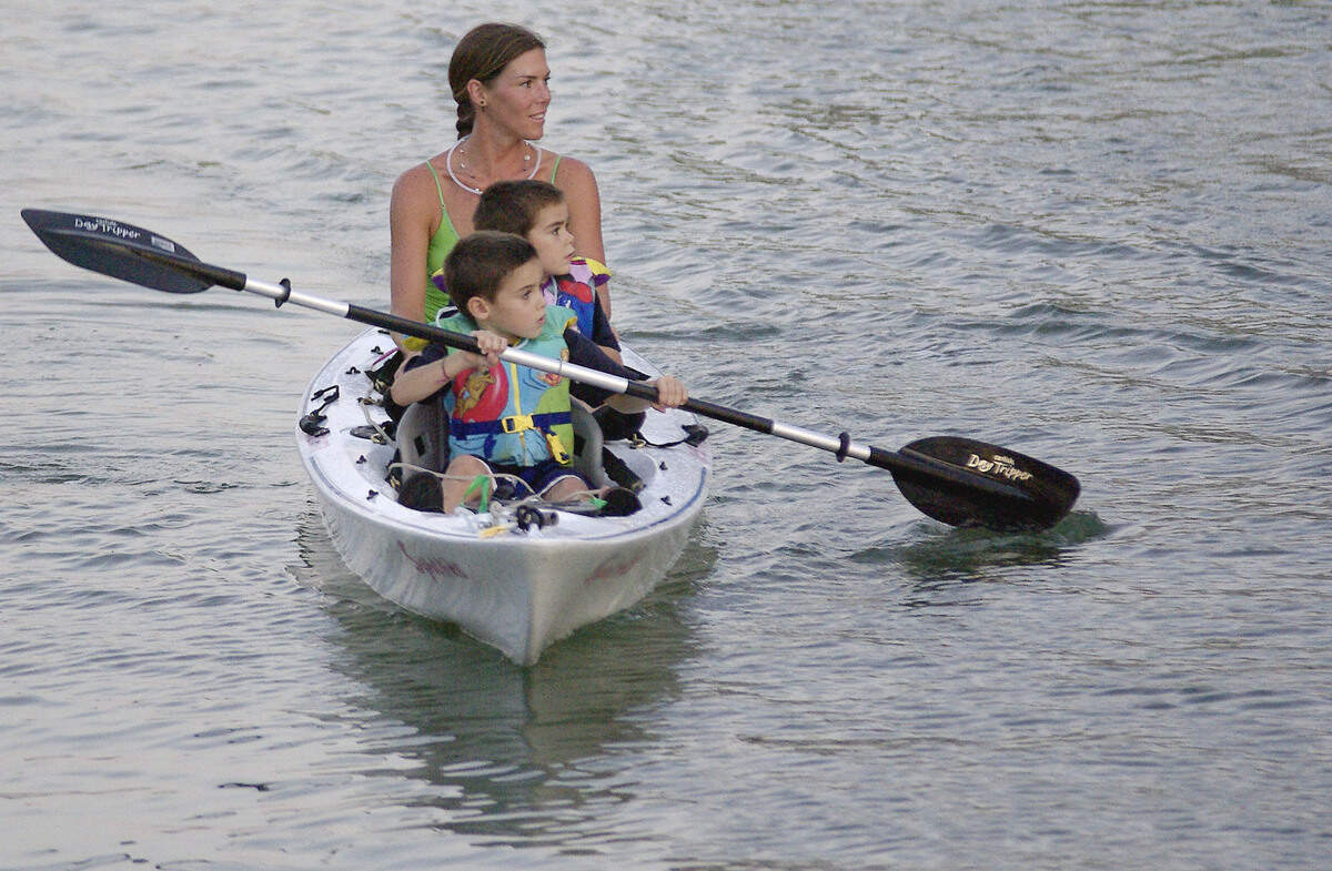 Gabriel Vizcarroneo, 5, (front) takes care of the paddling while little brother Sebastian Vizcarroneo, 4, (middle) and his mom Samantha Maisonnave enjoy the passing scenery during a North Beach full Moon Kayak Tour on the Intercostal Waterway in Miami Beach.  CHRIS CUTRO / FOR THE MAIMI HERALD.