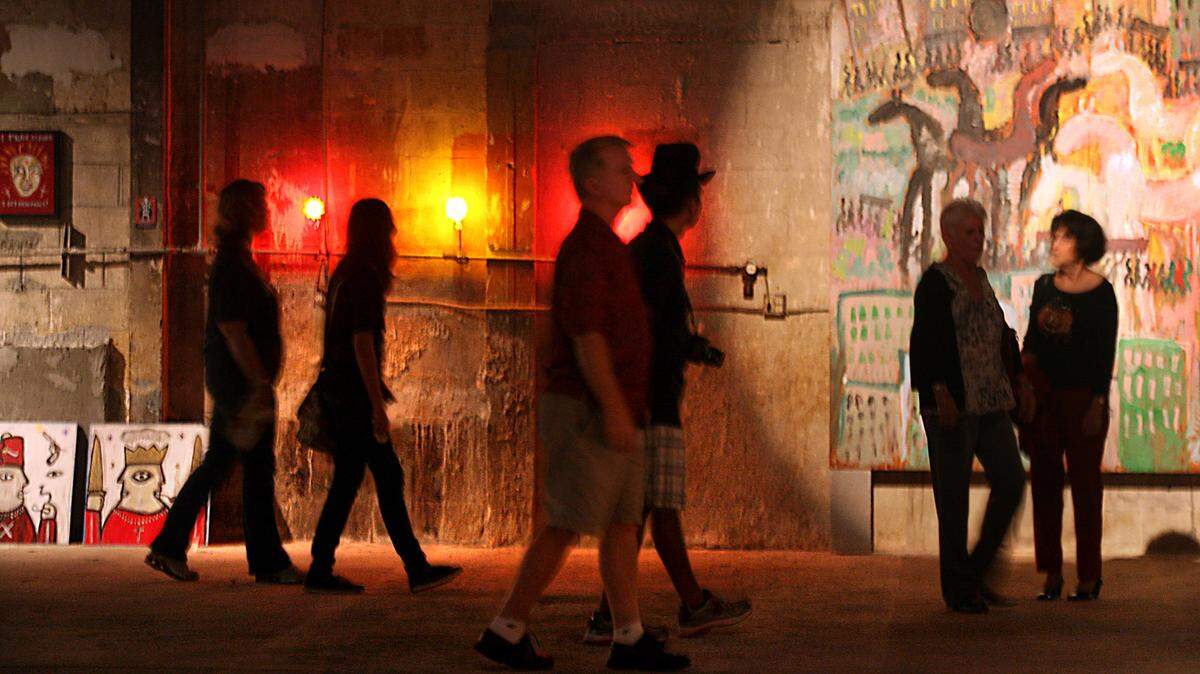 Art lovers stroll through one of several art galleries at FatVillage Arts District in Fort Lauderdale.  Studios, galleries, two black box theaters and businesses dedicated to the arts are open for artwalks that feature music and refreshments every 4th Saturday of every month and for special occasions.