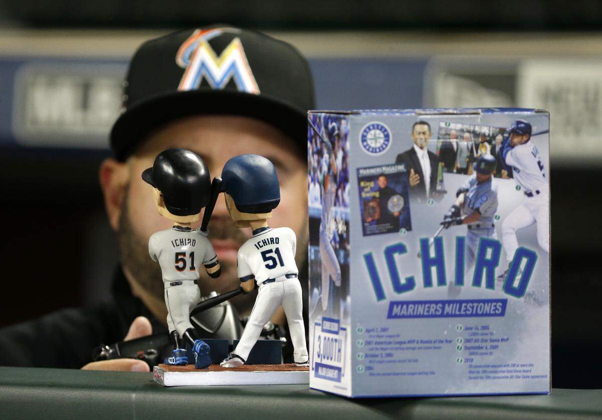 A dual bobble head showing Miami Marlins' Ichiro Suzuki wearing a Marlins jersey and a jersey from his former team, the Seattle Mariners, and commemorating his 3,000-hit milestone, is shown before a baseball game against the Mariners, Monday, April 17, 2017, in Seattle. (AP Photo/Ted S. Warren)