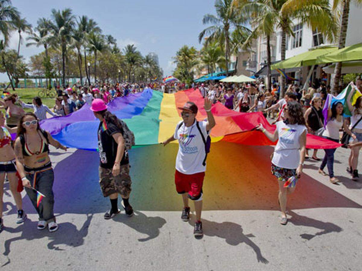 A group carries a gigantic rainbow flag during Miami Beach Gay Pride on Sunday April 14, 2013. Photo: Patrick Ferrell