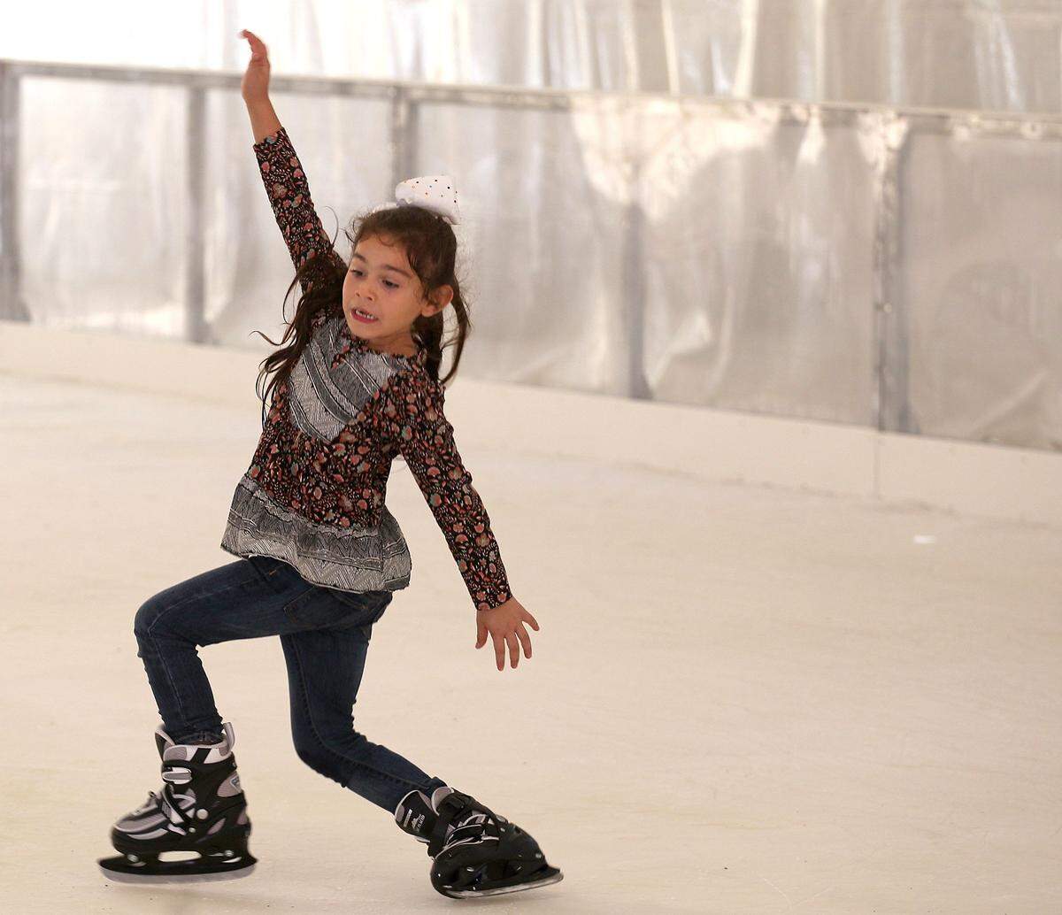 Sophia Gamboa tries to keep her balance while trying to skate at the "Panthers in the Park" outdoor ice skating rink.