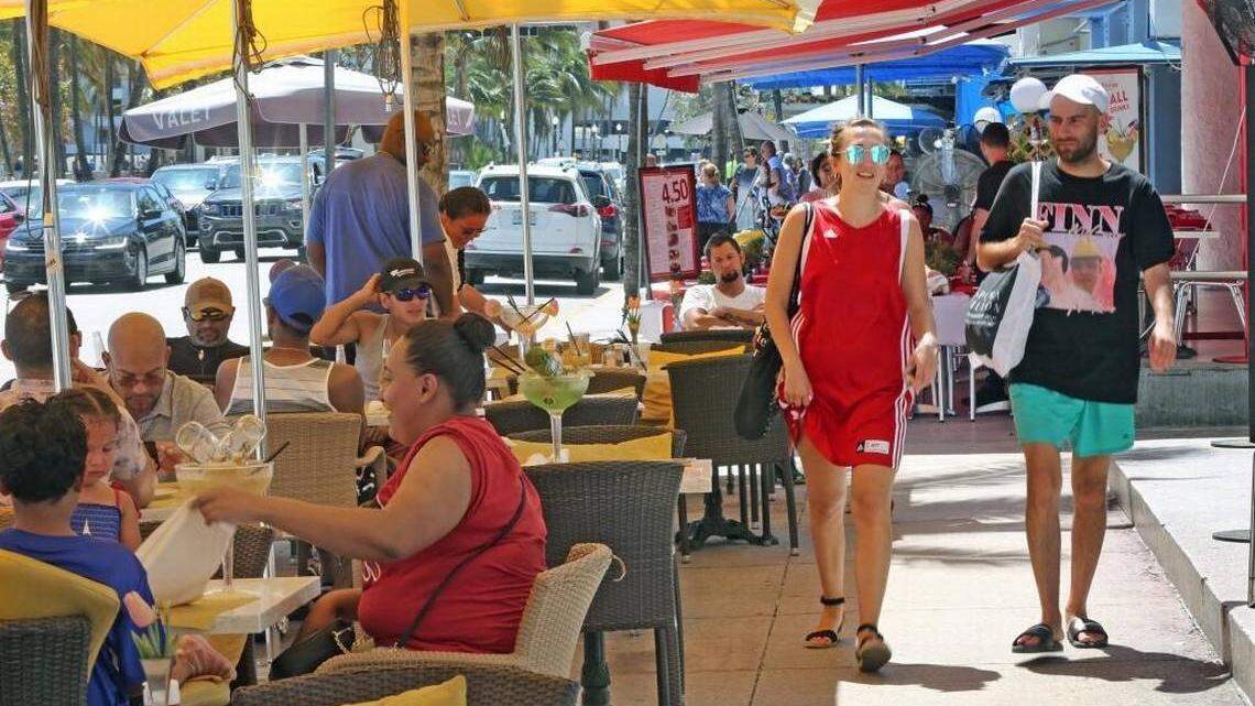 On a sunny Sunday, crowds enjoy drinks and meals on Ocean Drive. Sometimes the good feelings stop when the bill arrives.