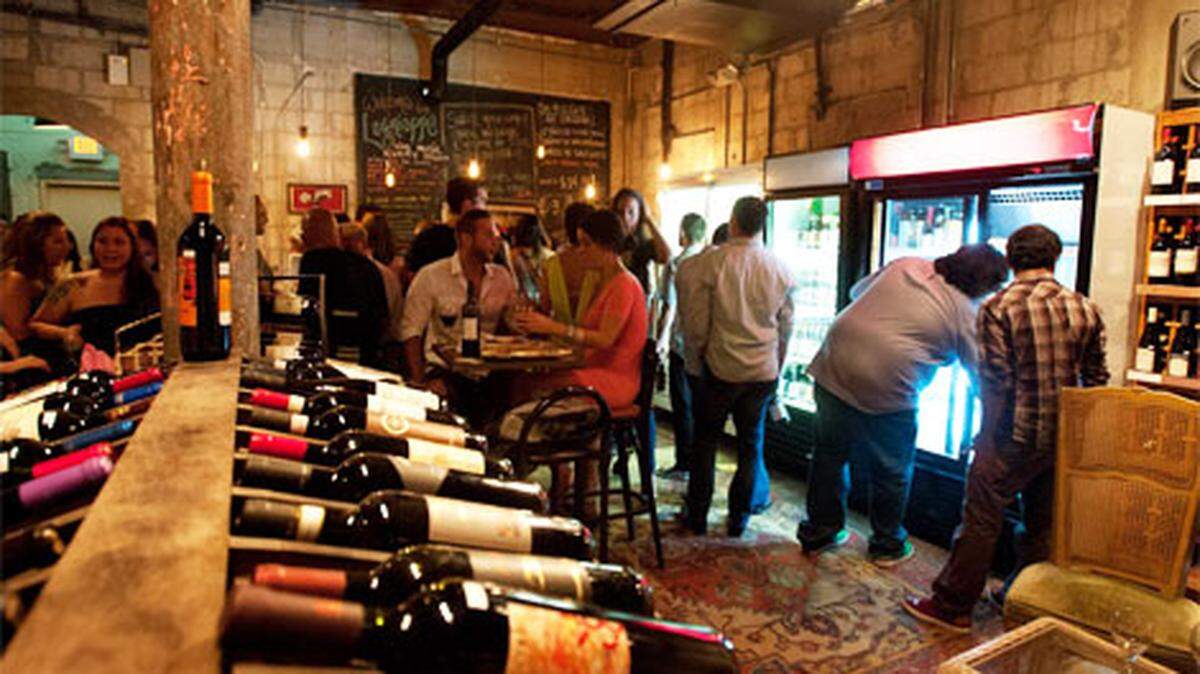 Patrons eat and drink at Lagniappe House. Located at 3425 NE 2nd Ave., the shop sells wine, beer and food. Photo: Daniel Bock
