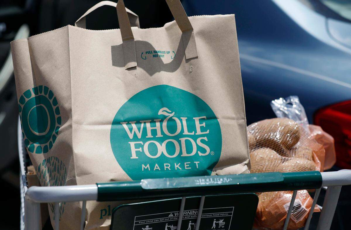 A Whole Foods Market purchase awaits placement in a car trunk. (AP Photo/Rogelio V. Solis)