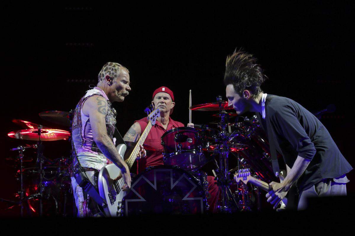 Bassist Flea, from left, drummer Chad Smith and guitarist Josh Klinghoffer, of the Red Hot Chili Peppers, perform on stage at the Verizon Center on Wednesday, April 12, 2017, in Washington, D.C. (Photo by Brent N. Clarke/Invision/AP)