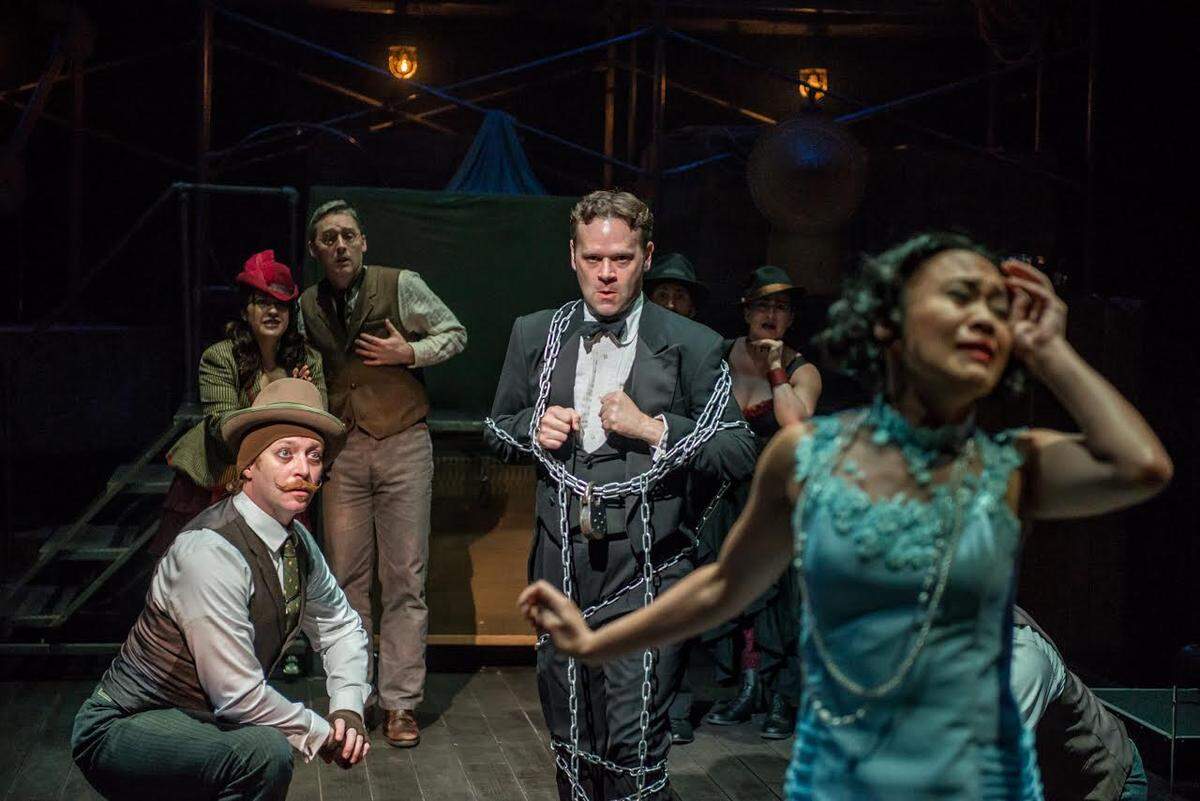 Break these chains! Dennis Watkins (as Harry Houdini) gets ready to escape.