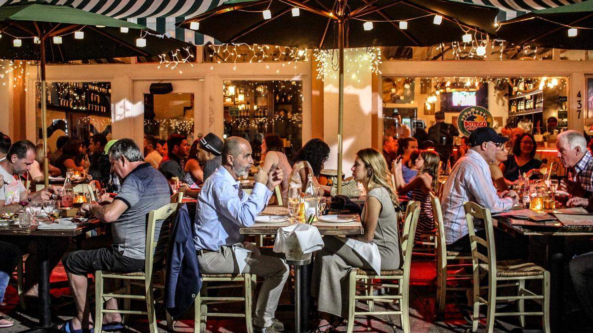 Tourists pack Española Way, especially in season. But developers and business owners hope to lure locals with a discount card.