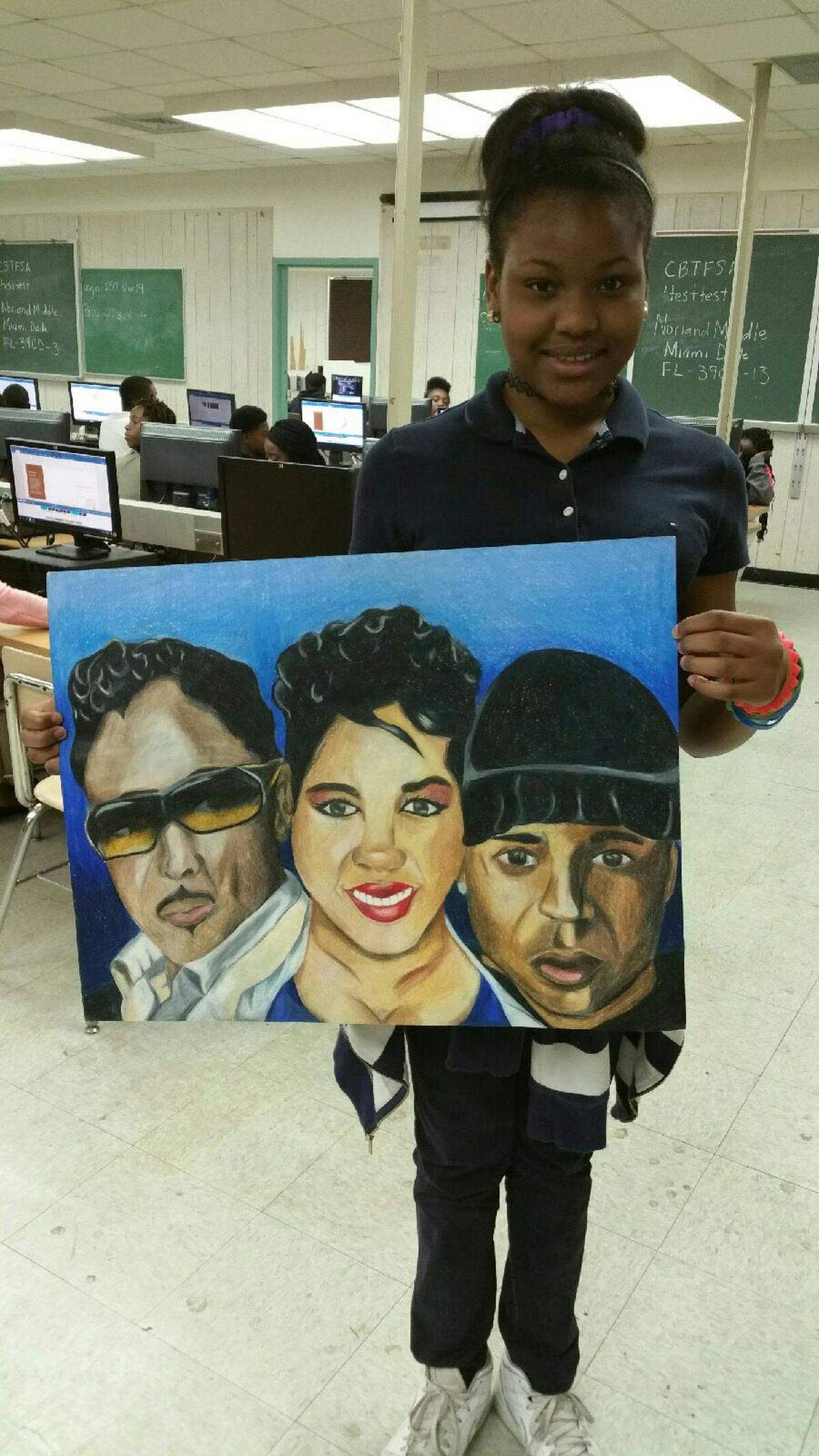 Kaleen Thompson, a 14-year-old 8th grader at Norland Middle in Miami Gardens holds her painting that was chosen to be on the cover of the Miami Herald's Weekend Section.
