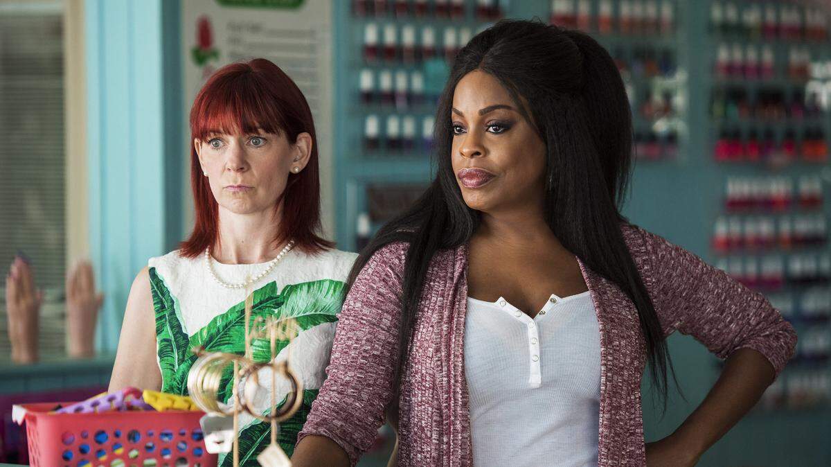 This image released by TNT shows Carrie Preston, left, and Niecy Nash from the new series, "Claws," which is about a nail salon in South Florida. (Wilson Webb/TNT via AP)