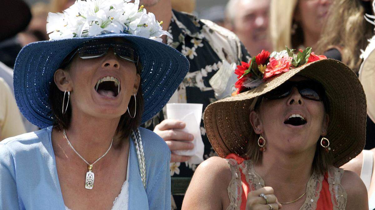 Tracy Owsley and Stephanie Sullivan, from Salem, Ind., cheer their winning horse during the second race at Churchill Downs Racetrack, Friday, May 5, 2006 in Louisville, Ky. (AP Photos/Darron Cummings)