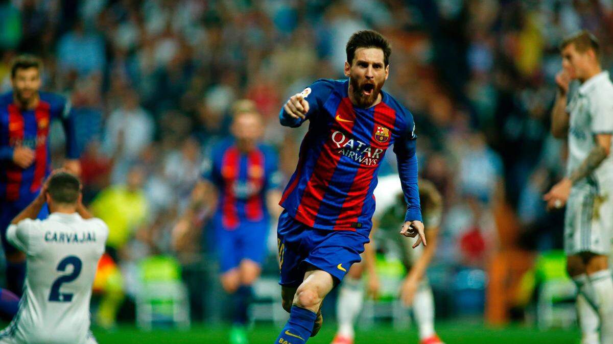 Barcelona's Argentinian forward Lionel Messi celebrates after scoring during the Spanish league Clasico football match Real Madrid CF vs FC Barcelona at the Santiago Bernabeu stadium in Madrid on April 23, 2017. / AFP PHOTO / OSCAR DEL POZO        (Photo credit should read OSCAR DEL POZO/AFP/Getty Images)