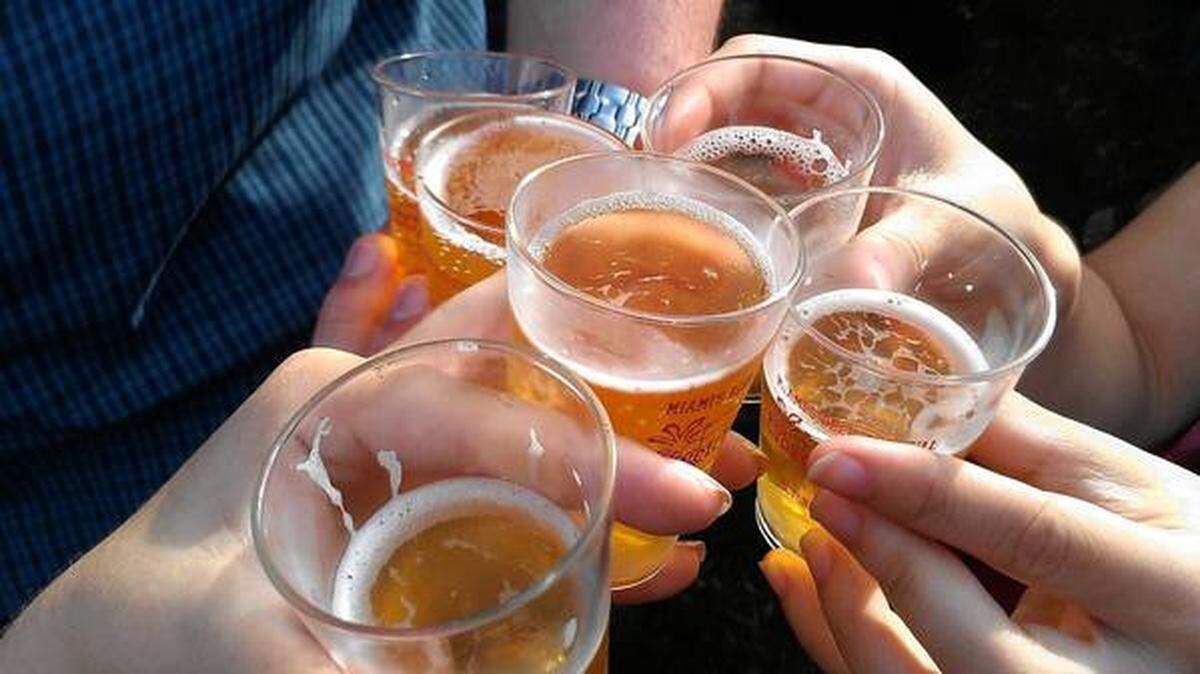 Revelers toast with tasting glasses at Grovetoberfest.