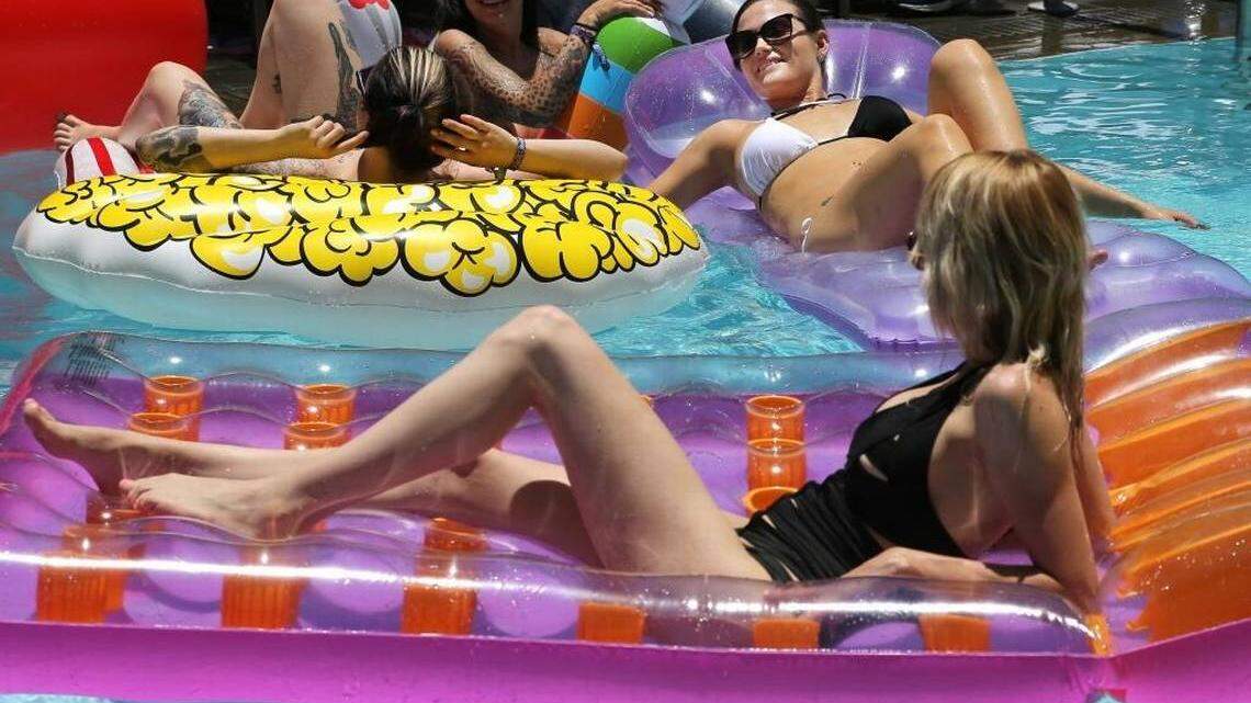 ‘Camming’ models sunbathe in the pool at the SLS South Beach hotel during the Cam Con trade show in Miami Beach. The industry celebrates its fifth anniversary this week on South Beach.