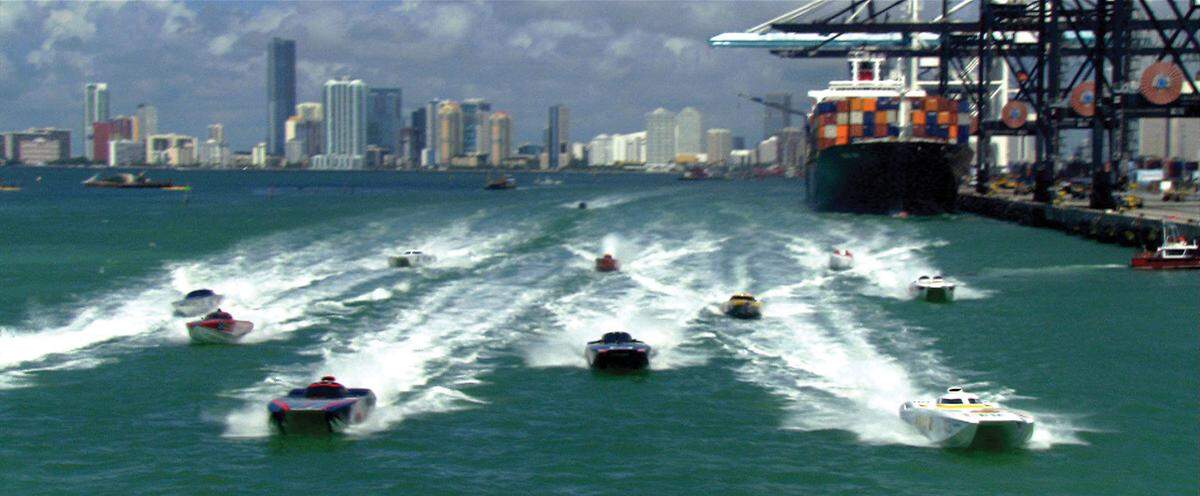Speedboats racing in a scene from “Miami Vice”