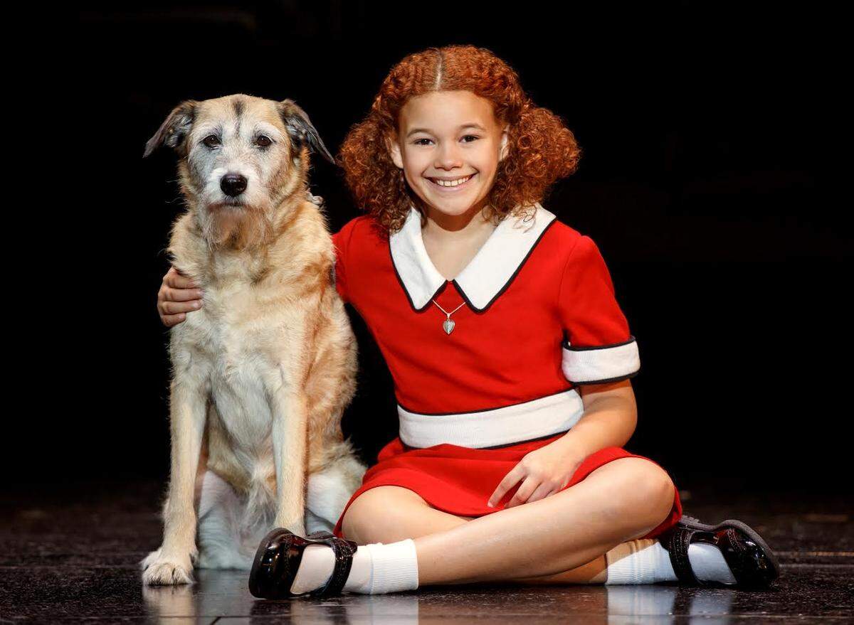 Tori Bates is the orphaned Annie; Macy plays her sidekick Sandy.