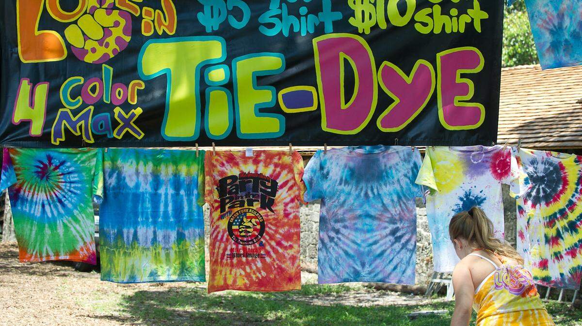 Loren Vaneuveln, a volunteer from North Miami Beach, makes tie-dyed shirts during the 12th-annual Love-In Party in the Park at Greynolds Park in North Miami Beach, Sunday, May 3, 2015. More than 1000 people turned out for the music festival, which was presented by Catholic Health Services. The event featured five musical acts, a car show, and vendors of food, arts, and crafts.