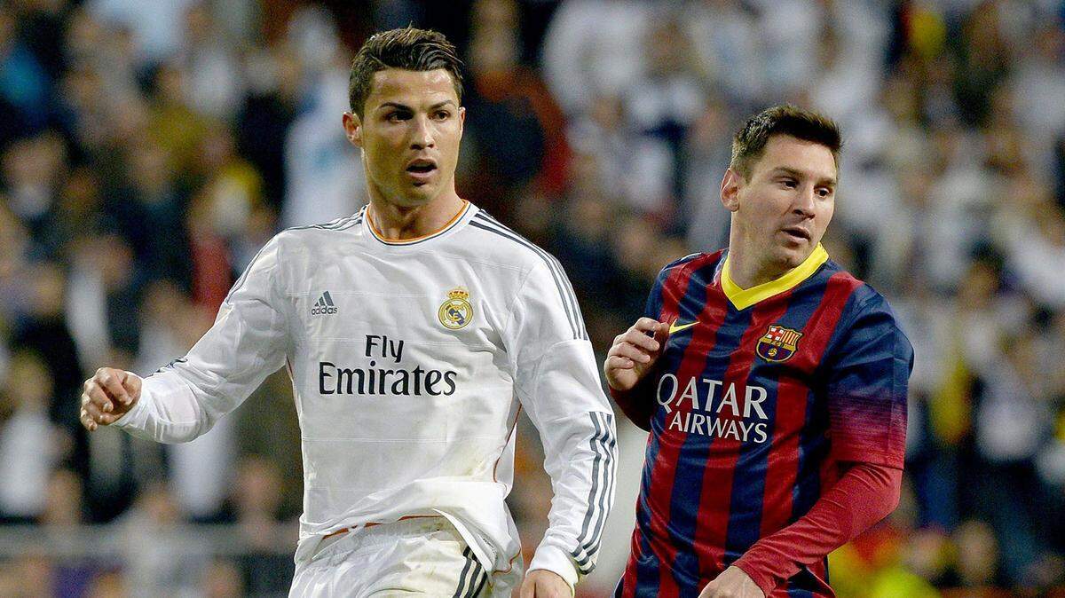 Real Madrid's Portuguese forward Cristiano Ronaldo (L) and Barcelona's Argentinian forward Lionel Messi look on during the Spanish league "Clasico" football match Real Madrid CF vs FC Barcelona at the Santiago Bernabeu stadium in Madrid on March 23, 2014.   AFP PHOTO/ GERARD JULIEN        (Photo credit should read GERARD JULIEN/AFP/Getty Images)