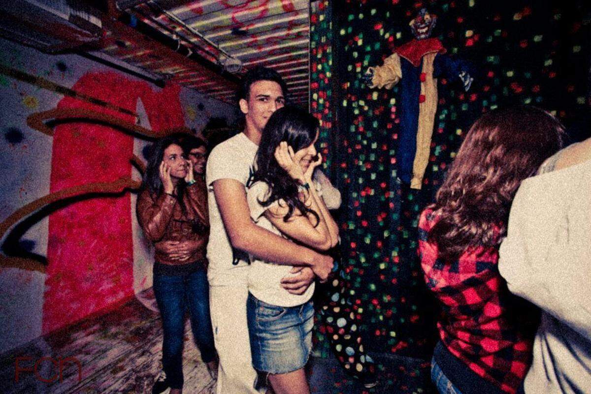 Freaked out couple hold on to each other while walking through creepy hallways. (Handout)