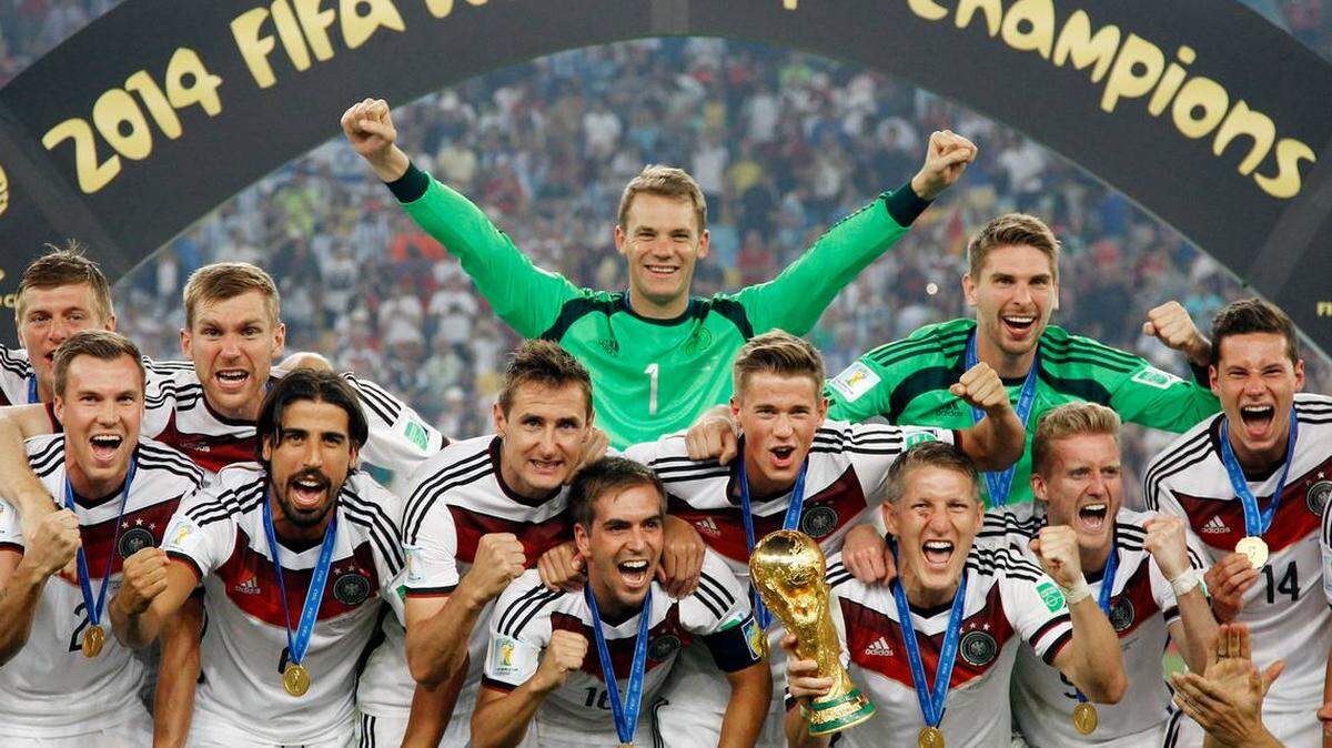 German players celebrate with the trophy after the World Cup final soccer match between Germany and Argentina at the Maracana Stadium in Rio de Janeiro, Brazil. July 13, 2014
