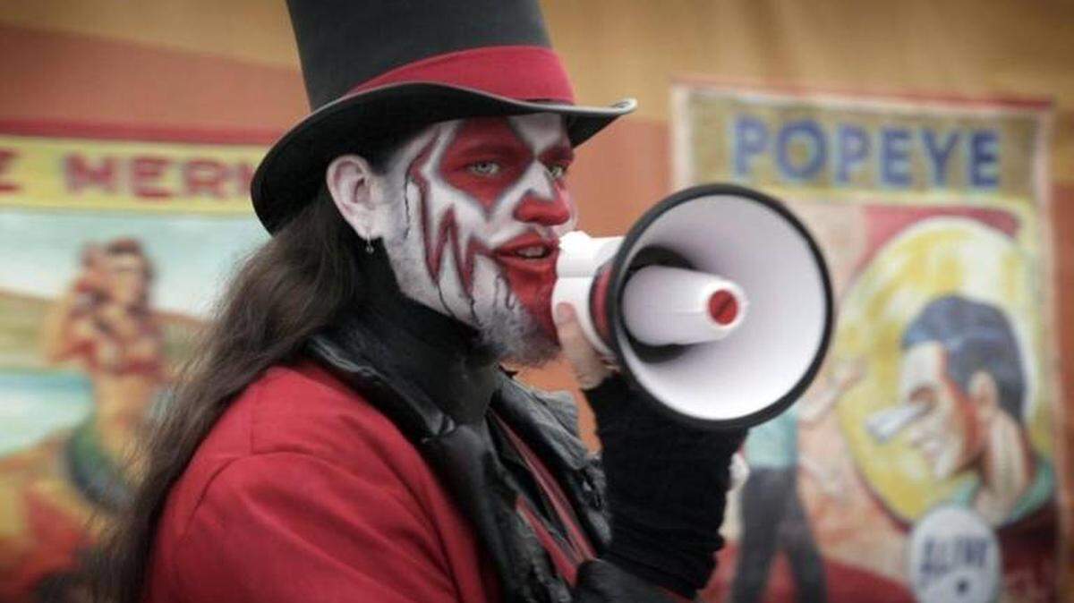 Michael Calkins uses his megaphone to lure carnival-goers to the Freak Show tent at the House of Horror Haunted Carnival at Miami International Mall. October 5, 2017.