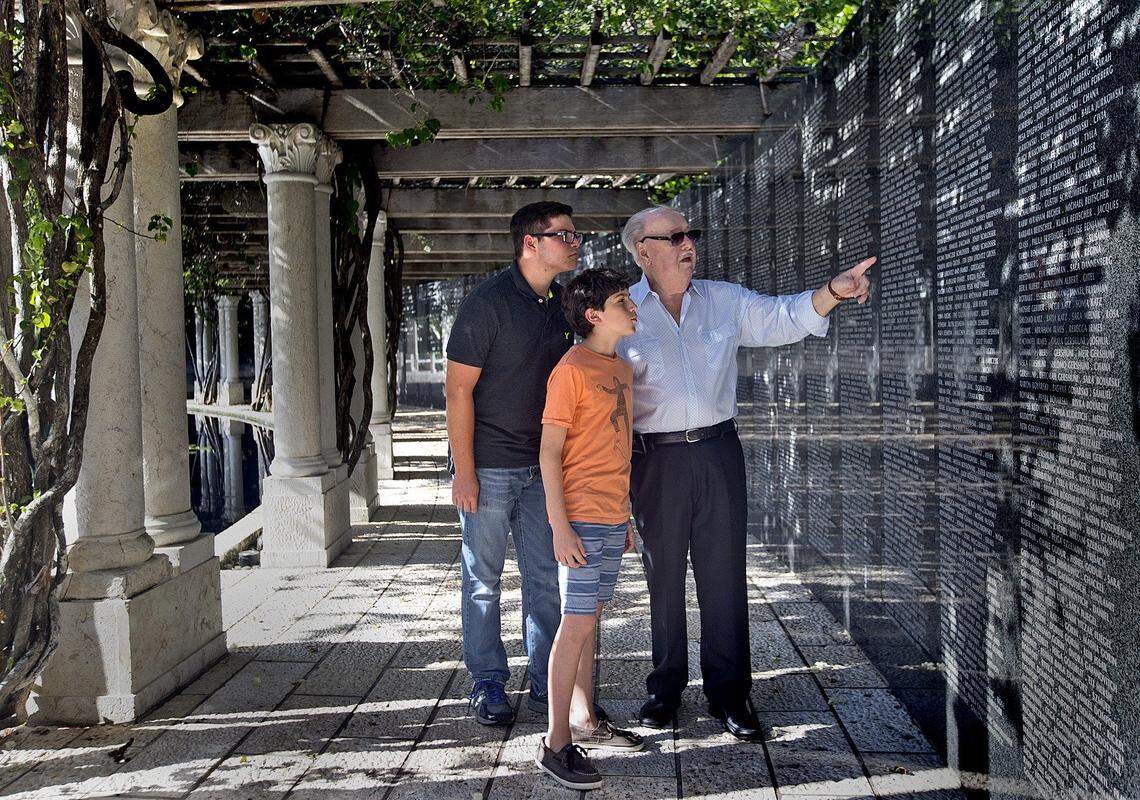 Brothers  Kyle 12,  and Cameron Behar 15  chat with  Holocaust survivor Fred Mulbauer 85  as he points out his parents names at the Holocaust Memorial on Tuesday September 8, 2015.