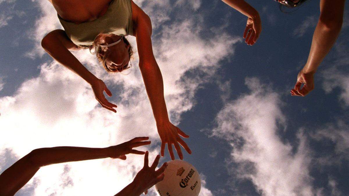DADE--2/24/01--PHOTO BY JON KRAL--VOLLEYPLAOOZA ON SOUTH BEACH-- Volleypalooza is a model volleyball challenge to raise money for the Police Athletic League on Miami Beach. The Aura Agency warms up for the volleyball game they are about to play. Top--Antonella Giannantonio, Elaine Fayad and Amanda Perez (bottom)