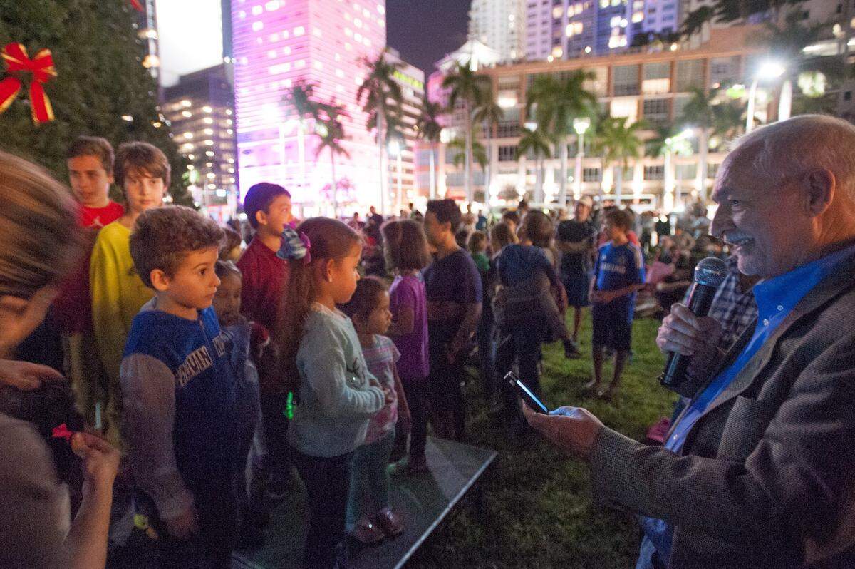 Timothy Schmand, executive director of Bayfront Park Management Trust, leads children in a countdown to the lighting of the 30-foot Christmas tree at the park, Friday, Nov. 27, 2015, in Downtown Miami.