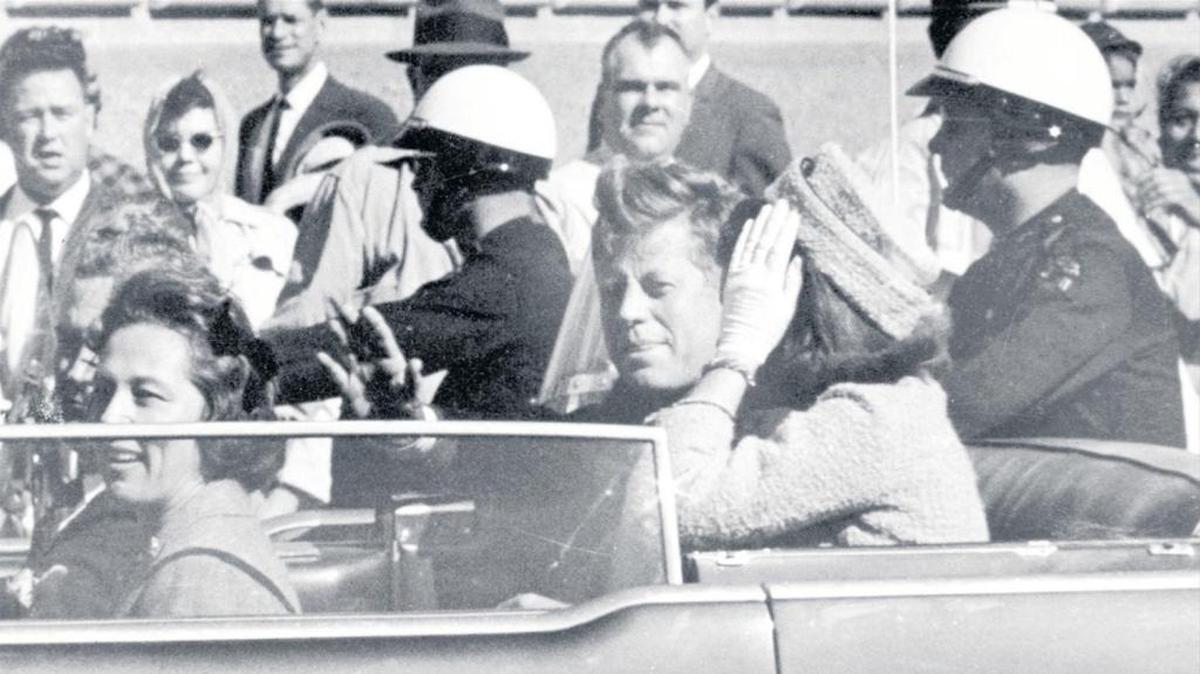 In this Nov. 22, 1963, photo, President John F. Kennedy waves from his car in a motorcade in Dallas. Riding with Kennedy are First Lady Jacqueline Kennedy, right, Nellie Connally, second from left, and her husband, Texas Gov. John Connally, far left.