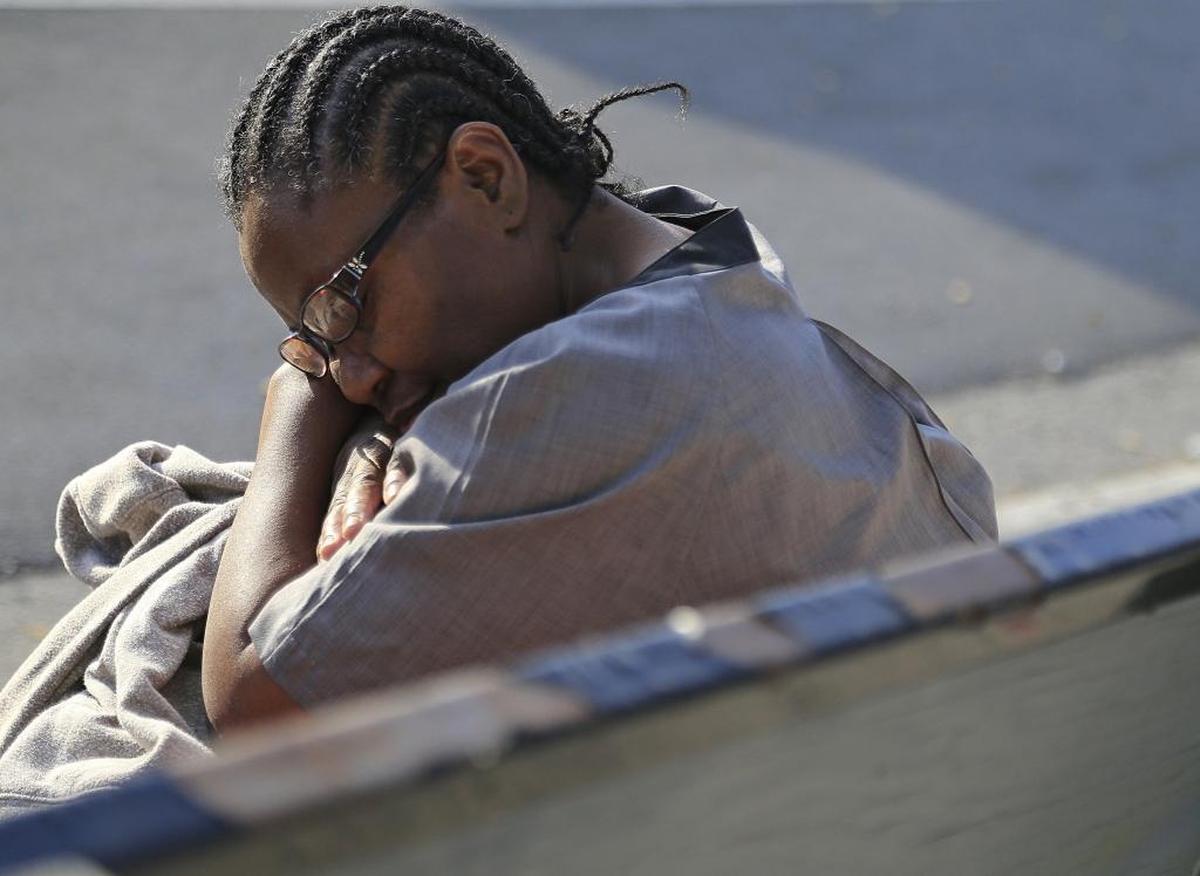 Fontainebleau housekeeper Odelie Paret takes a short nap between buses on her commute home from the hotel. This April afternoon, her two-bus commute takes nearly two hours to bridge the 13.5-mile gap between hotel and home.