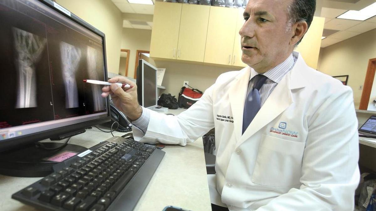 
Area of expertise: OrthoNOW CEO and Chief Medical Officer Dr. Alejandro Badia, an orthopedic surgeon, reviews X-rays of a wrist fracture at the orthopedic care center in Doral. OrthoNOW is building a network of orthopedic urgent care centers and OrthoNOW Doral is the flagship location.
