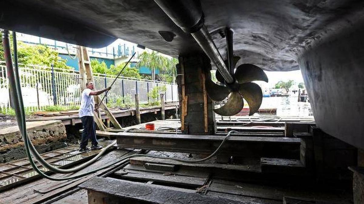 Devon King, an employee at RMK Merrill-Stevens, paints a hull on Oct. 7, 2014. CEO Mike Frank, says the company is looking to hire several of these certified technicians in the next year for its repair and maintenance services.