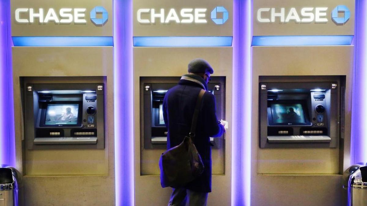 In this Wednesday, Jan. 14, 2015, file photo, a customer uses an ATM at a branch of Chase Bank, in New York. JPMorgan Chase, Wells Fargo and other big banks are upgrading their online payment services to let customers make instant transfers of money to others who bank elsewhere, often at no cost.