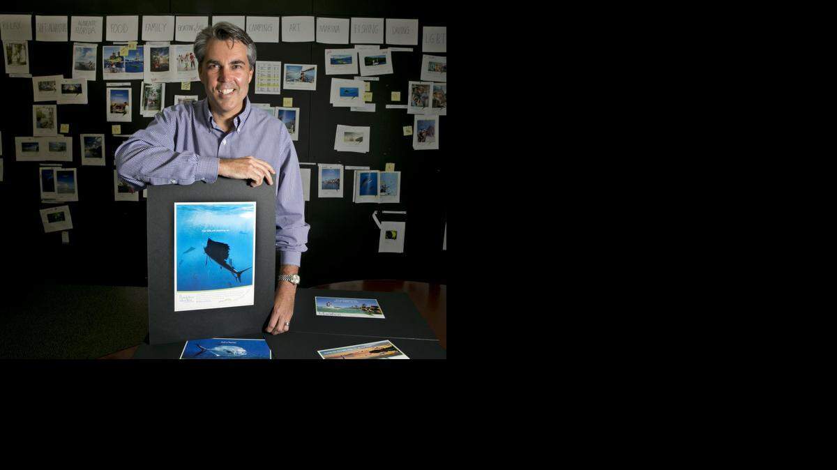 
John Underwood, chief marketing officer at Tinsley Advertising, says the agency works to come up with campaigns that use a play on words.  This is Underwood at Tinsley Adevertising offices on Tuesday, October 21, 2014. The advertisement uses a billfish as a trigger for its word play and says “Our Bills Are Stacking Up.”
