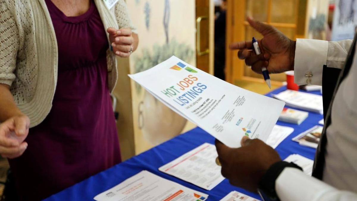 Military veteran Mark Cannon, of Miami, right, talks with Cynthia Carcillo, left, a veterans outreach representative for Career Source Broward, about employment opportunities at an October job fair for veterans, in Pembroke Pines. U.S. employers advertised fewer jobs in October 2015, though overall hiring picked up and quits rose slightly, adding to evidence the job market is slowly improving.