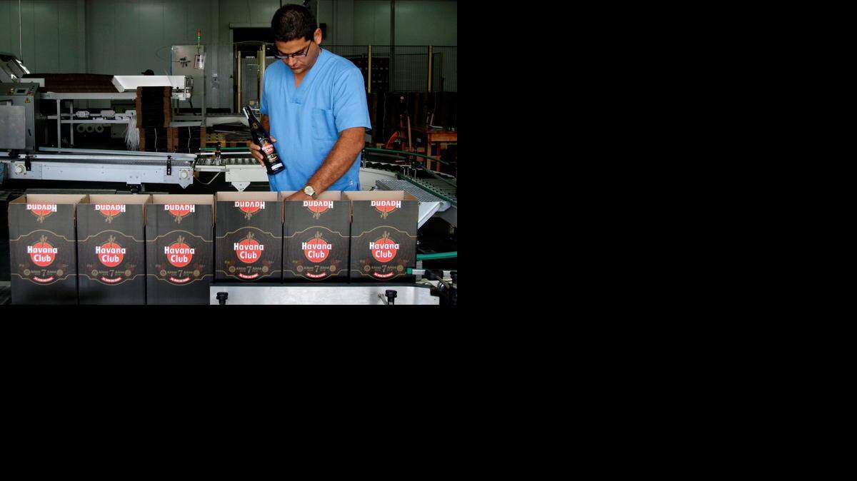 
In this Oct. 22, 2010, file photo, a worker checks the production of Havana Club rum at the company's factory in Havana, Cuba. U.S. rum aficionados are abuzz over the potential for making Cuba Libres with Cuban rum, now that Americans visiting the Caribbean island will be allowed to bring home rum distilled there for the first time since the embargo took effect 55 years ago. 
