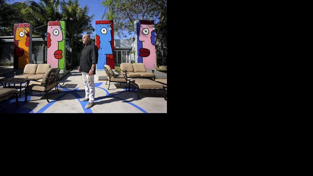 
Miami Ironside developer Ofer Mizrahi stands in the courtyard on Friday, near segments of the Berlin Wall painted by Berlin artist Thierry Noir. 

