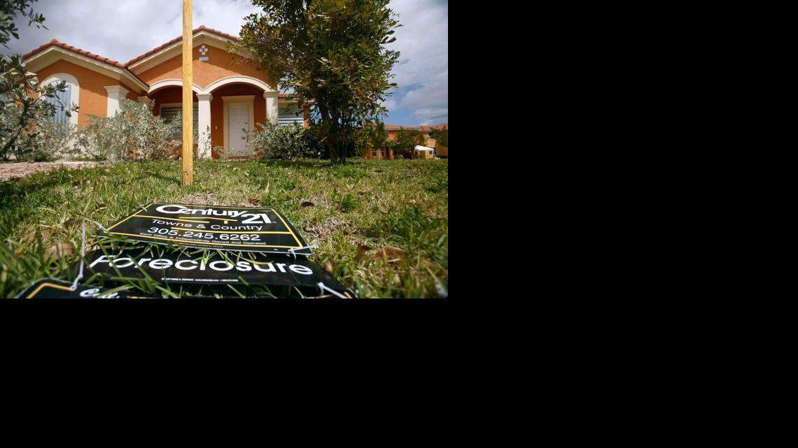 
A “for sale” sign lays on the ground in front of a foreclosed home in Homestead during the recession in 2009.
