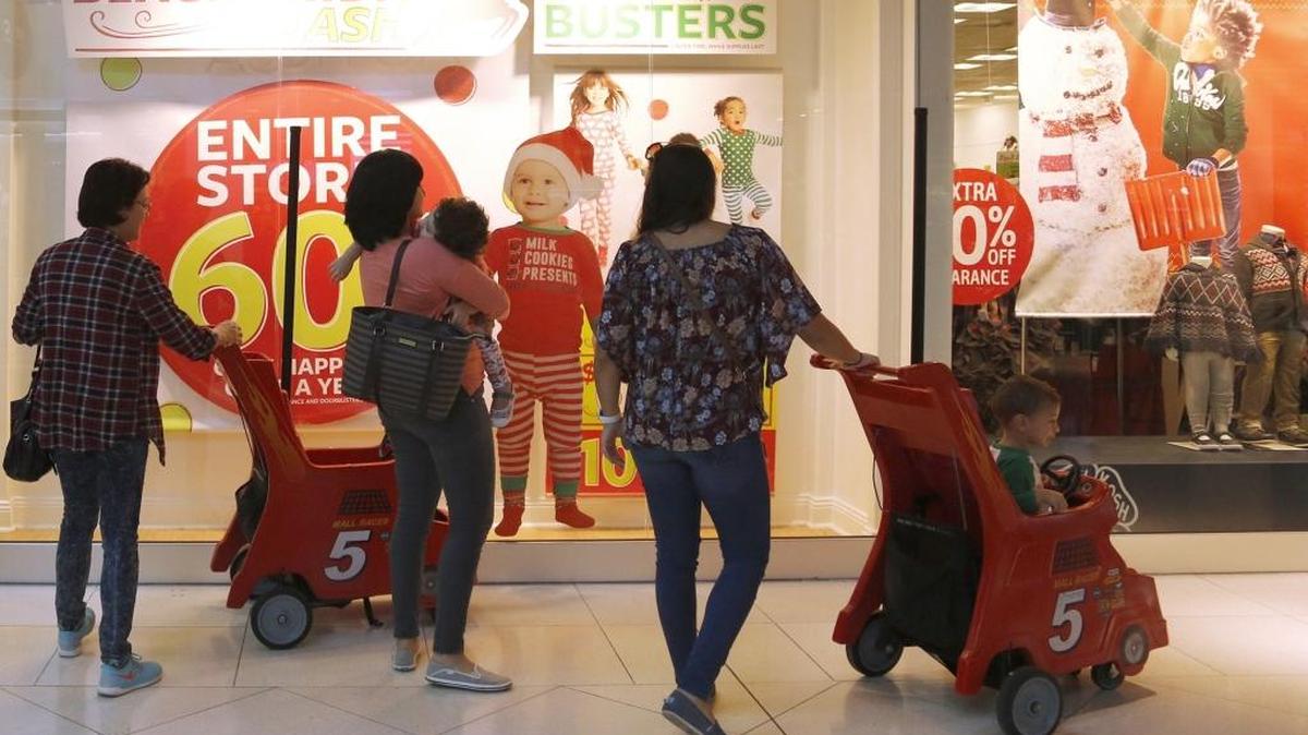Stores advertise Black Friday sales to draw the attention of shoppers at Dolphin Mall in 2016.