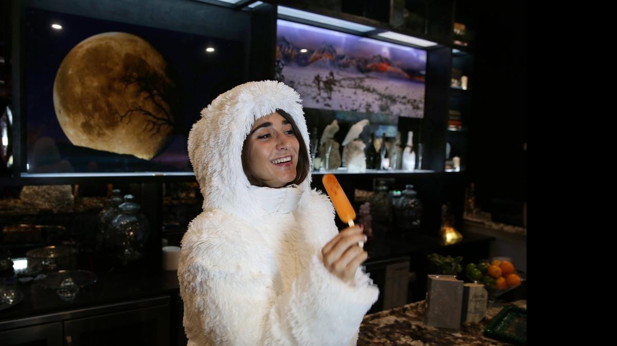 
Nicole Pritchett eats an ice-pop cocktail called "Sun Scorched" inside Drinkhouse Fire & Ice in Miami Beach.
