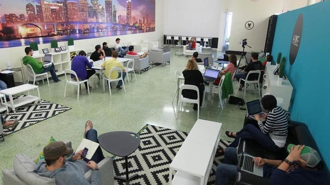 Tech startup tech entrepreneurs work at Venture Hive in downtown Miami. Venture Hive is an entrepreneurial education center, one of many resources in South Florida.