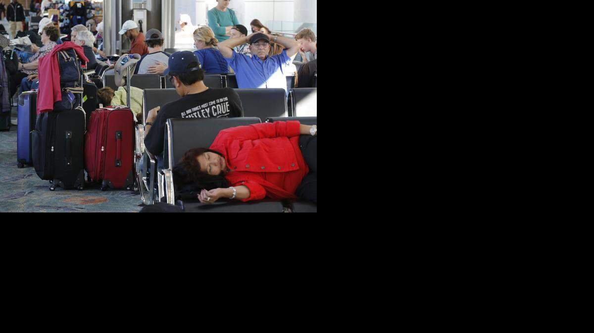 
Holiday travelers sit, sleep, and relax while waiting to depart from Fort Lauderdale-Hollywood International Airport, Terminal 1 on Monday.
