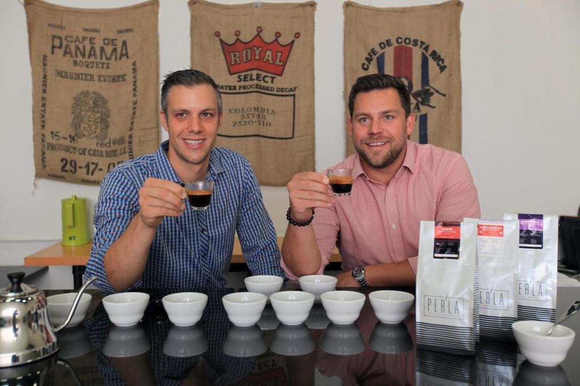 From left, Per’la Specialty Roasters co-founders Chris Nolte and Paul Massard, pictured at the company’s roasting facility in West Miami-Dade. Per’La roasts about 900 pounds of coffee each week, which it sells to area hotels, restaurants and cafes.